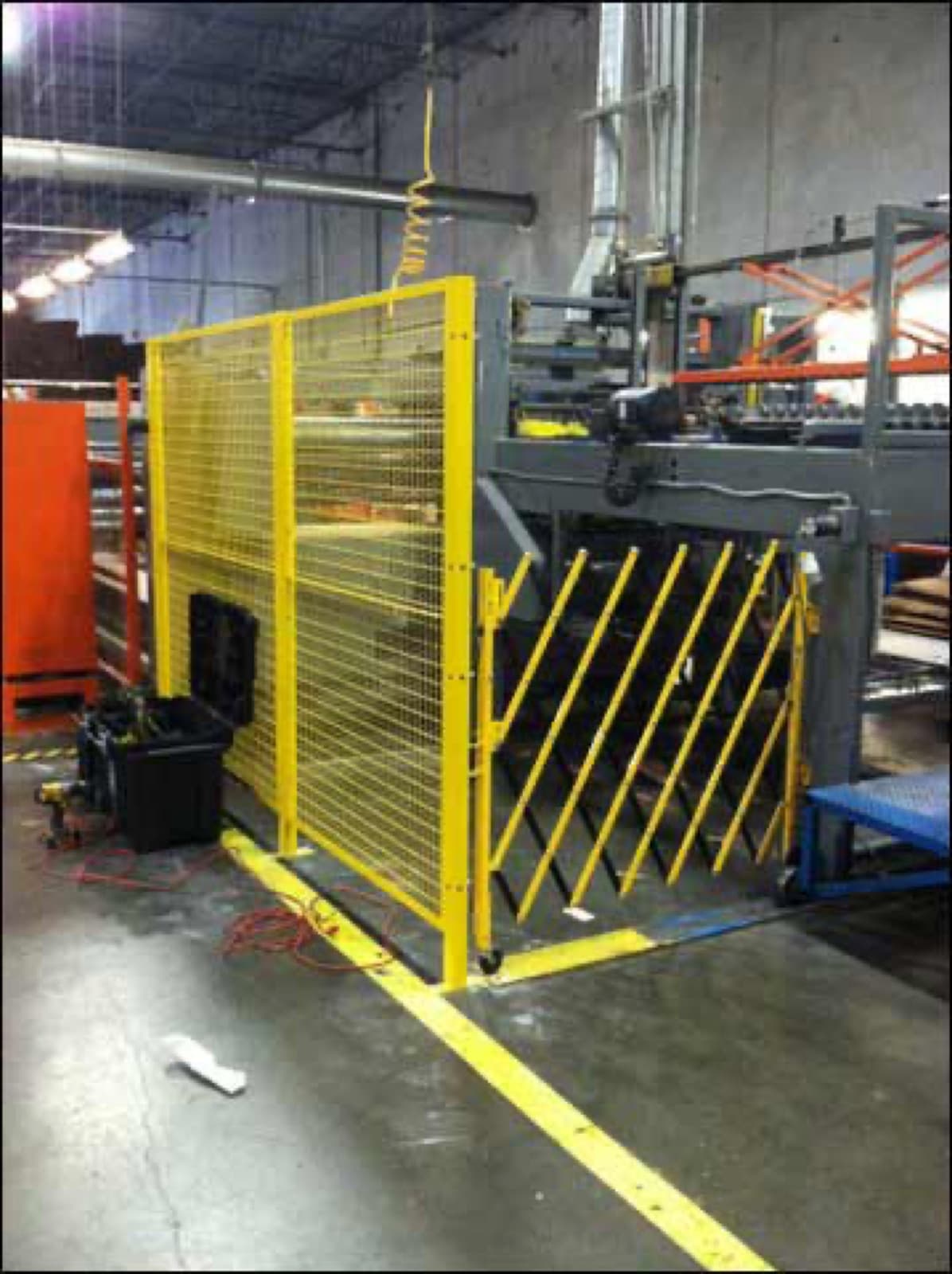 Press brake with yellow scissor gate and side fencing