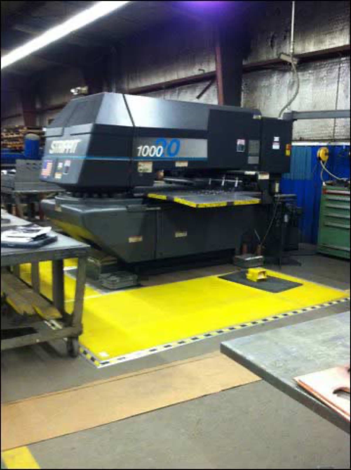 Strippit turret press with bright yellow safety mat